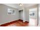 Bright bedroom featuring a window, an open closet, light gray walls, and red wood flooring at 3031 W 20Th Ave, Denver, CO 80211