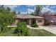 Classic brick home boasts a manicured lawn, mature trees, and inviting curb appeal at 3031 W 20Th Ave, Denver, CO 80211