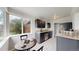 Cozy kitchen with dark cabinets, stainless steel appliances, and a charming breakfast nook perfect for casual dining at 3031 W 20Th Ave, Denver, CO 80211