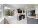 Functional kitchen featuring dark cabinetry, stainless steel appliances, and a sunny breakfast nook with garden views at 3031 W 20Th Ave, Denver, CO 80211