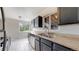 Spacious kitchen featuring stainless appliances, granite countertops, and modern dark cabinets at 3031 W 20Th Ave, Denver, CO 80211