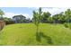 Large backyard featuring a play area, mature trees, and well-manicured lawn at 4879 S Johnson St, Littleton, CO 80123