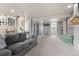 Finished basement showcasing the open layout, neutral carpeting, and access to other areas at 4879 S Johnson St, Littleton, CO 80123