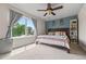 Bedroom with a large window, ceiling fan, blue accent wall, and bookshelf at 4879 S Johnson St, Littleton, CO 80123