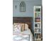 Bedroom with wood headboard, white bookshelf and blue wall paint at 4879 S Johnson St, Littleton, CO 80123