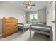 Bedroom with twin beds, neutral gray walls, ceiling fan and carpeted floors at 4879 S Johnson St, Littleton, CO 80123