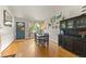 Inviting dining room with hardwood floors, stylish decor, and an open view to front door and entryway at 4879 S Johnson St, Littleton, CO 80123