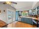 Modern kitchen with stylish blue cabinets, stainless steel appliances, and a view of the backyard patio at 4879 S Johnson St, Littleton, CO 80123