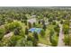 A nice aerial view of community tennis courts and a pond surrounded by mature trees at 6128 S Coventry E Ln, Littleton, CO 80123