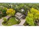 Stunning aerial view of a home surrounded by mature trees on a lush green property at 6128 S Coventry E Ln, Littleton, CO 80123
