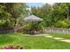 Charming backyard area featuring a patio set under a striped umbrella, perfect for outdoor dining and relaxation at 6128 S Coventry E Ln, Littleton, CO 80123