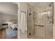 Beautiful bathroom featuring tiled walk-in shower and view of bedroom at 6128 S Coventry E Ln, Littleton, CO 80123