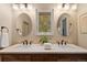Bathroom featuring a double sink vanity with marble countertop and custom cabinets at 6128 S Coventry E Ln, Littleton, CO 80123