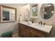 Bathroom featuring a double sink vanity with marble countertop and custom cabinets at 6128 S Coventry E Ln, Littleton, CO 80123
