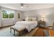 Bright bedroom with hardwood floors, a ceiling fan, and a large window at 6128 S Coventry E Ln, Littleton, CO 80123