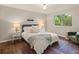 Comfortable bedroom with large window offering abundant natural light and views at 6128 S Coventry E Ln, Littleton, CO 80123