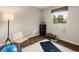 Bright exercise room featuring hardwood floors, a large window, and natural light at 6128 S Coventry E Ln, Littleton, CO 80123