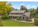 Beautiful home with lush lawn and professional landscaping, nestled amongst mature trees at 6128 S Coventry E Ln, Littleton, CO 80123