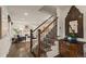 Inviting foyer with hardwood floors, staircase, and views into the living and dining areas at 6128 S Coventry E Ln, Littleton, CO 80123