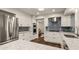 Modern kitchen featuring white cabinets, granite countertops, stainless steel appliances and tile backsplash at 6128 S Coventry E Ln, Littleton, CO 80123