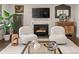 Cozy living room featuring a fireplace, stylish decor, and comfortable seating at 6128 S Coventry E Ln, Littleton, CO 80123