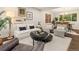 Cozy living room with stylish decor, hardwood floors, and an open layout flowing into the dining area at 6128 S Coventry E Ln, Littleton, CO 80123