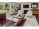 Relaxing living room with a fireplace, modern seating, and backyard access at 6128 S Coventry E Ln, Littleton, CO 80123