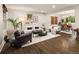 Bright and airy living room with hardwood floors, stylish furniture, and an open-concept design at 6128 S Coventry E Ln, Littleton, CO 80123