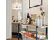 Chic bar area with open shelving and stylish decor, leading to a modern bathroom at 799 Dahlia St # 503, Denver, CO 80220