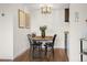 Charming dining room featuring modern lighting, a wooden table set for four, and hardwood floors at 799 Dahlia St # 503, Denver, CO 80220