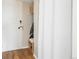 Inviting entryway with hardwood floors, built-in shelving, and a private coat closet at 799 Dahlia St # 503, Denver, CO 80220