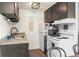 Well-equipped kitchen with granite countertops, dark cabinets, and appliances at 799 Dahlia St # 503, Denver, CO 80220