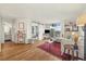 Open-concept living room with access to a balcony and view of bedroom through sliding barn door at 799 Dahlia St # 503, Denver, CO 80220
