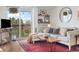 Comfortable living room with a balcony and a natural wood coffee table on a vibrant red rug at 799 Dahlia St # 503, Denver, CO 80220