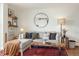 Cozy living room featuring a modern round mirror, decorative shelves, and a stylish coffee table at 799 Dahlia St # 503, Denver, CO 80220
