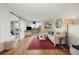 Inviting living room with a sliding barn door leading to another room and light hardwood flooring at 799 Dahlia St # 503, Denver, CO 80220