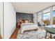 Bright main bedroom featuring a private balcony, modern paneling, and plush rug at 799 Dahlia St # 503, Denver, CO 80220