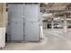 An indoor parking garage with secure metal storage bins, numbered for easy access at 799 Dahlia St # 503, Denver, CO 80220