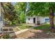 Detached garage in backyard with mature trees and green grass at 2845 Eaton St, Wheat Ridge, CO 80214