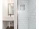 Modern bathroom with frameless shower, gray vanity, and modern fixtures at 2845 Eaton St, Wheat Ridge, CO 80214