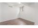 Basement bedroom featuring a window, neutral paint, and wood floors at 2845 Eaton St, Wheat Ridge, CO 80214