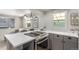 Modern kitchen featuring a gas range, stainless appliances, and an open design connecting to the living room at 2845 Eaton St, Wheat Ridge, CO 80214
