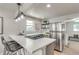 Modern kitchen with sleek stainless steel appliances, a gas range, and a stylish breakfast bar with seating at 2845 Eaton St, Wheat Ridge, CO 80214