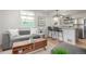 Bright living room featuring a modern sofa, stylish coffee table, and an open layout that flows into the kitchen at 2845 Eaton St, Wheat Ridge, CO 80214