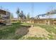 Spacious backyard with a mix of grassy areas and a fenced perimeter at 12425 Bellaire Dr, Thornton, CO 80241