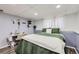 Bedroom featuring desk, a bed with green bedding and white blanket, and overhead lighting at 12425 Bellaire Dr, Thornton, CO 80241