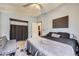 Bedroom featuring a large bed, dark walls, and an ensuite bathroom at 12425 Bellaire Dr, Thornton, CO 80241