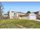 Well-maintained two-story home with a spacious front yard and attached garage at 12425 Bellaire Dr, Thornton, CO 80241