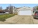 Two-story home with a large two car garage, a well manicured lawn, and a basketball hoop above the garage at 12425 Bellaire Dr, Thornton, CO 80241