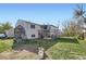 Exterior of the home showcasing the spacious backyard, deck, and play structure at 12425 Bellaire Dr, Thornton, CO 80241